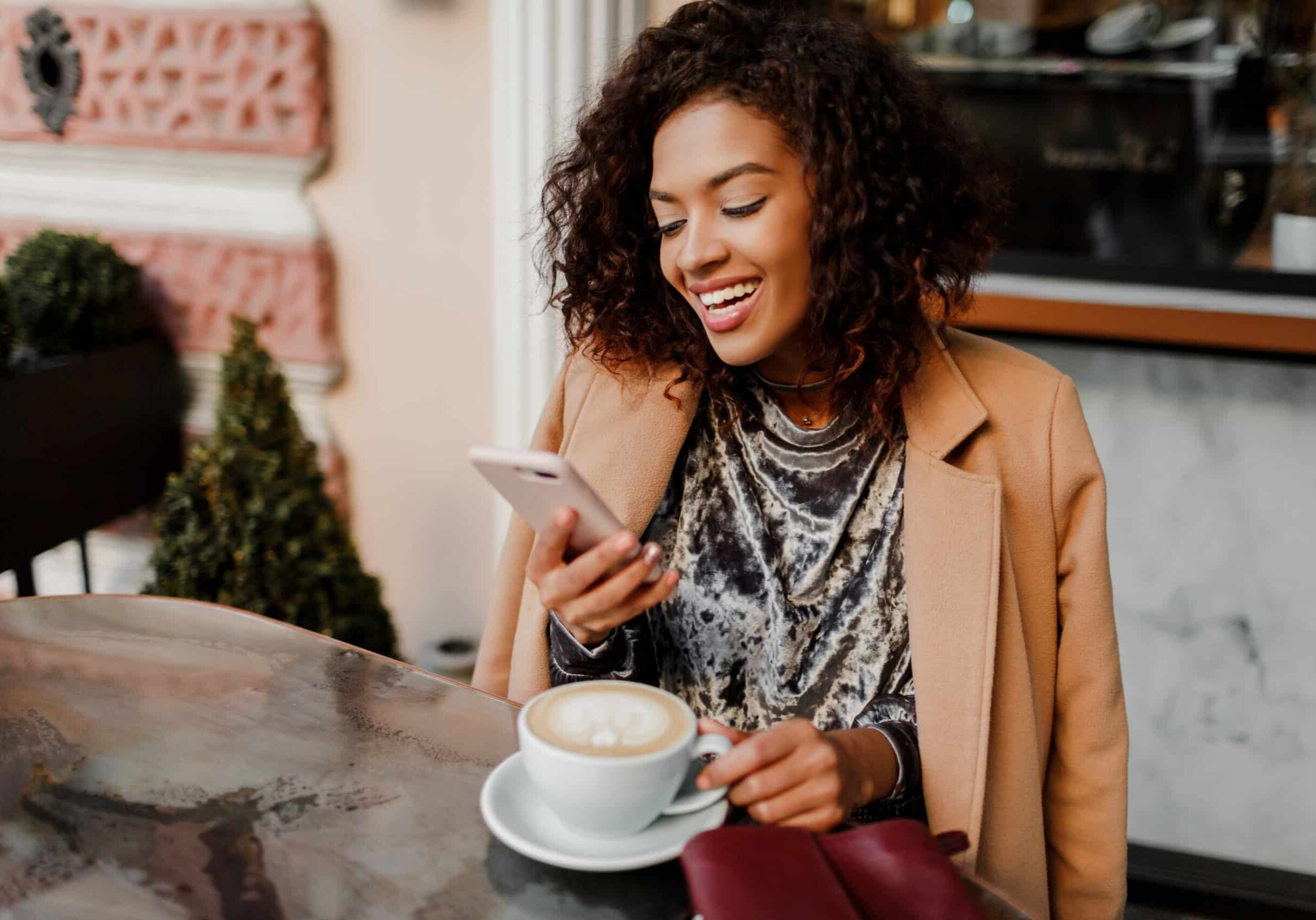 beautiful black woman smiling on her phone