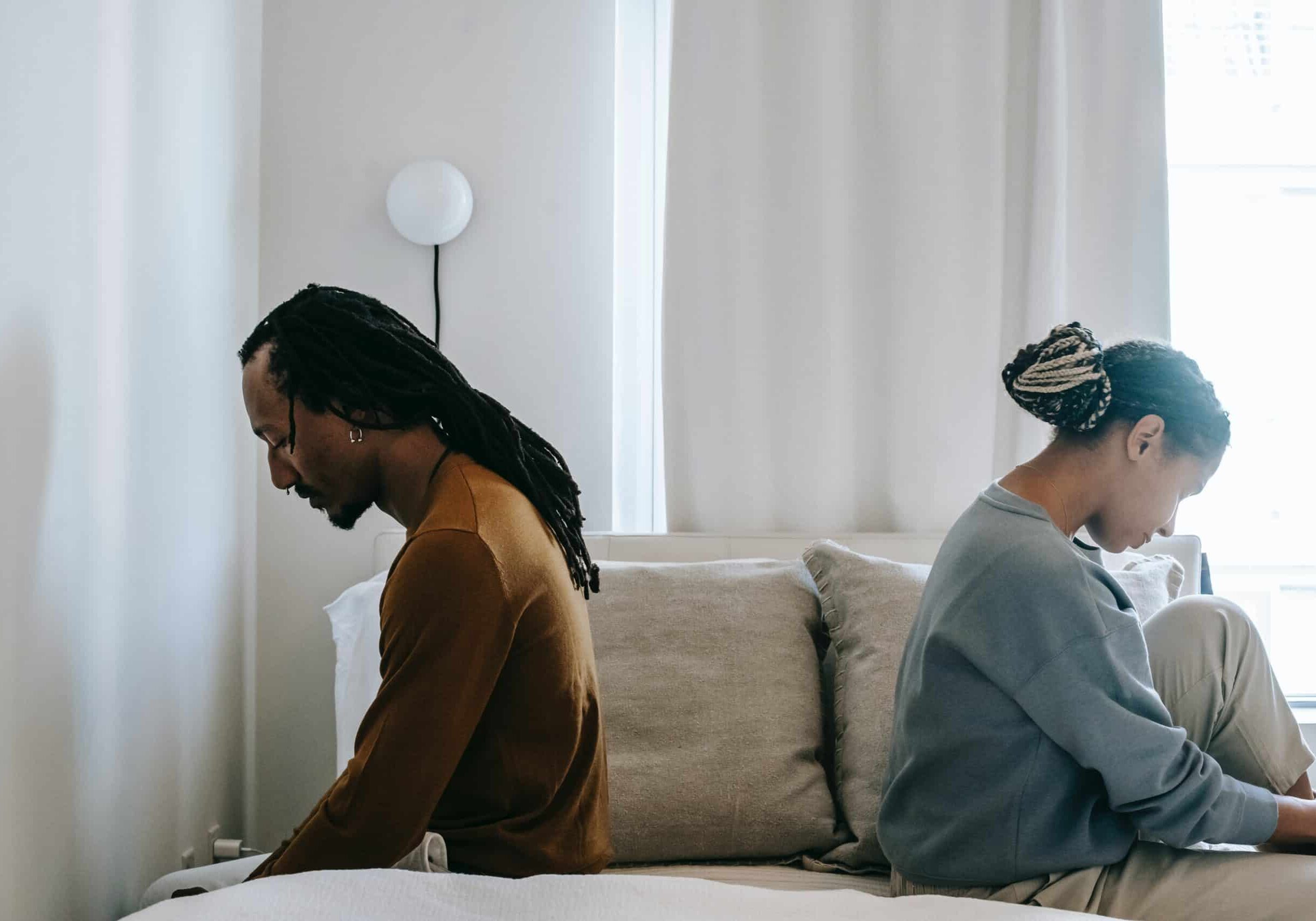 couple sitting with their backs to each other