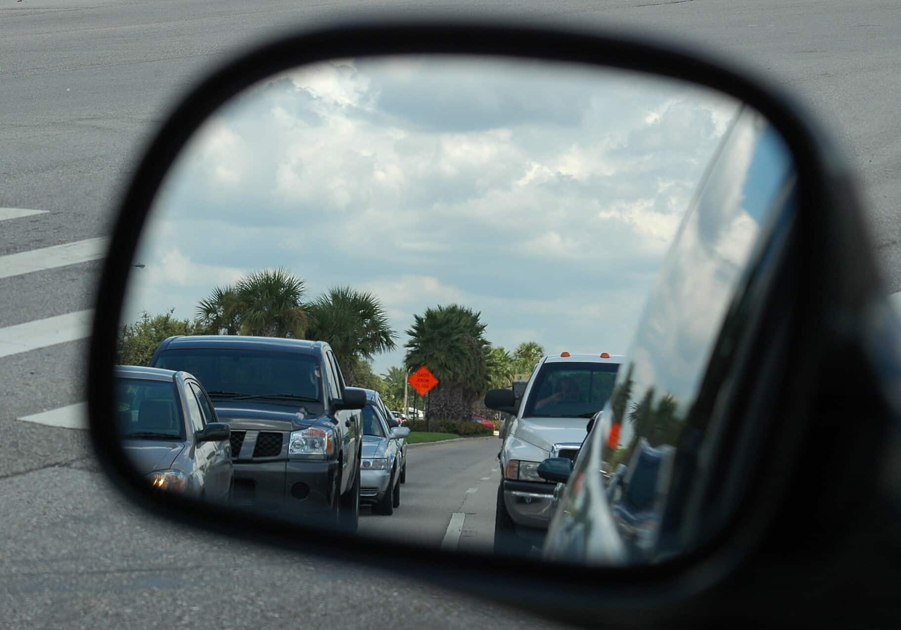 cars reflected in the side mirror.