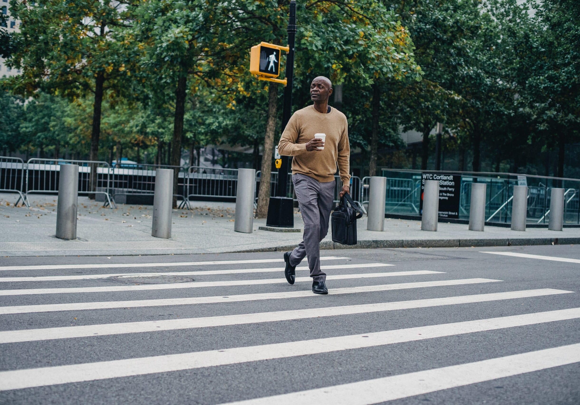 a black man crossing the pedestrian