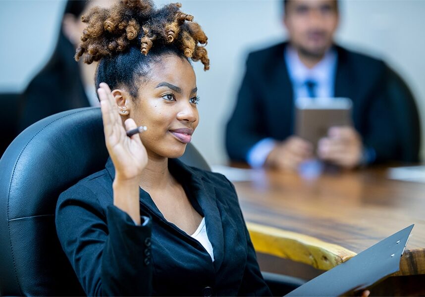 woman raising her hand to ask question