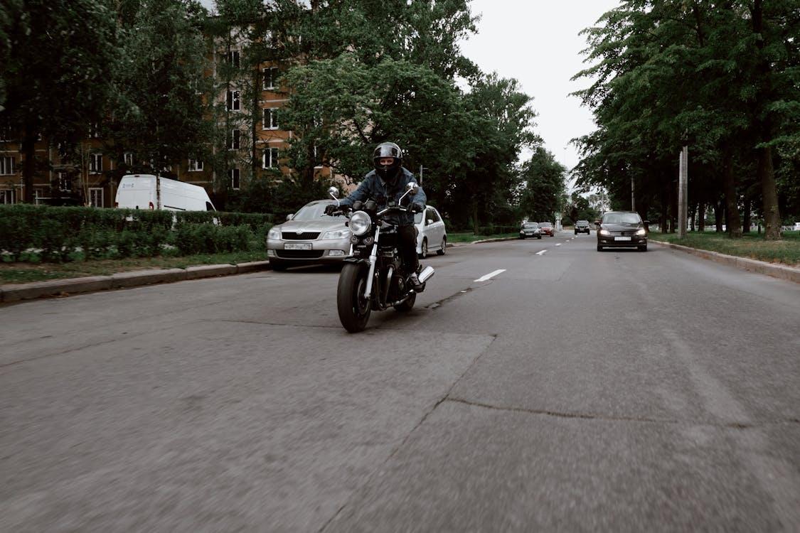 Free A Man Riding a Motorcycle on the Road Stock Photo